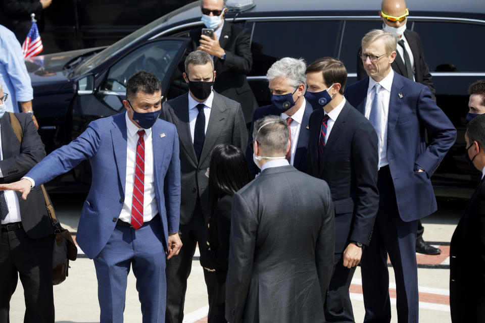 U.S. National Security Advisor Robert O'Brien, center right, and U.S. President Trump's senior adviser Jared Kushner, second from right, prepare to board a flight with an Israeli delegation to Abu Dhabi for talks meant to put final touches on the normalization deal between the United Arab Emirates and Israel, at Ben-Gurion International Airport, near Tel Aviv, Israel Monday, Aug. 31, 2020. (Nir Elias/Pool Photo via AP)