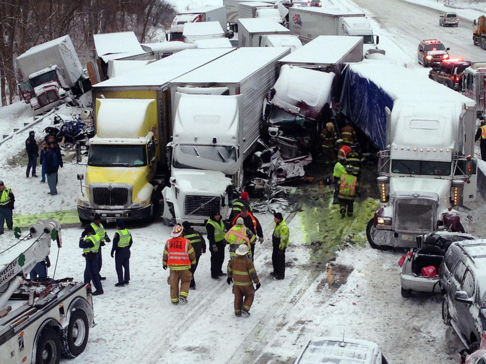 UPDATES NUMBER OF VEHICLES INVOLVED - In this photo provided by the Indiana State Police, emergency crews work at the scene of a massive pileup involving more than 40 vehicles, many of them semitrailers, along Interstate 94 Thursday afternoon, Jan. 23, 2014 near Michigan City, Ind. At least three were killed and more than 20 people were injured. (AP Photo/Indiana State Police)