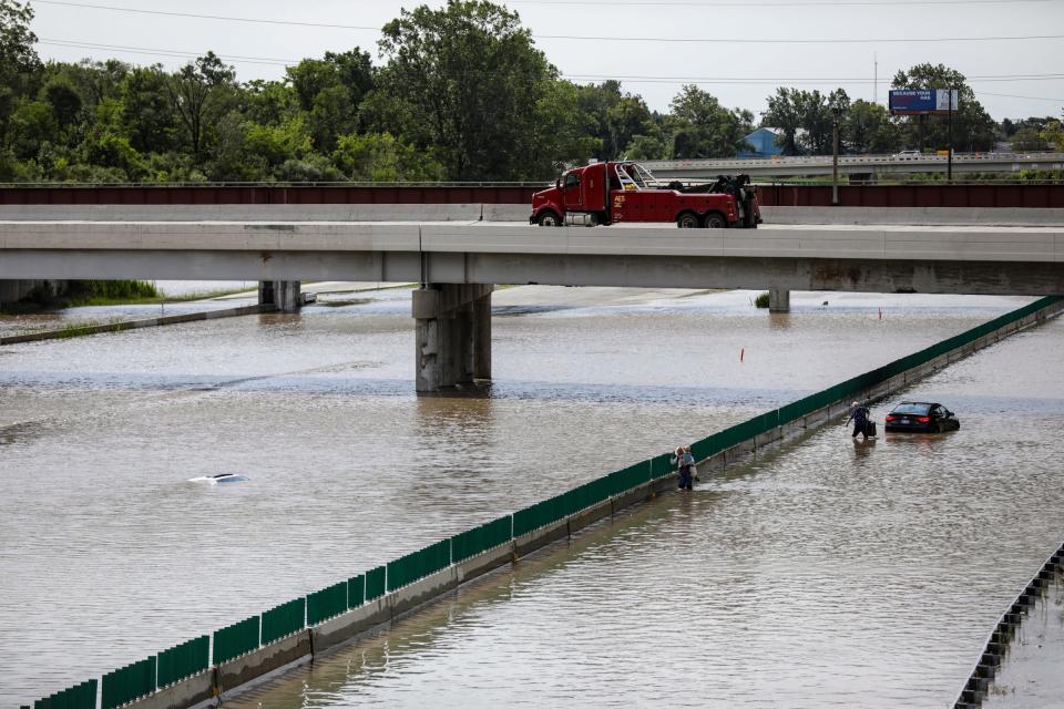 Flooding on Interstate 275 near Interstate 94 left some cars completely submerged and another family had to abandon their vehicle after their car stalled in the flooding near the Detroit Metropolitan Airport that left passengers and would-be travelers stranded on Thursday, Aug. 24, 2023.