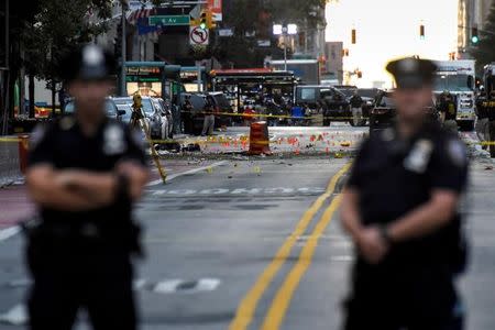 New York City Police Department (NYPD) officers stand near the site of an explosion in the Chelsea neighborhood of Manhattan, New York, U.S. September 18, 2016. REUTERS/Rashid Umar Abbasi