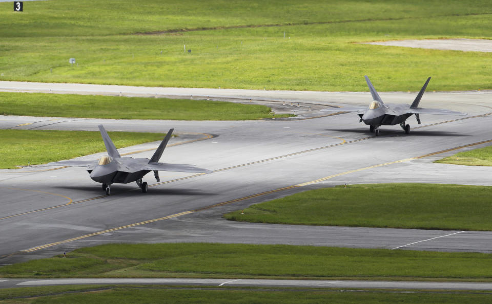 In this Aug. 14, 2012 photo, two U.S. Air Force F-22 Raptors taxi before take off from Kadena Air Base on the southern island of Okinawa, in Japan. The deployment of a dozen F-22 stealth fighters to Japan has so far gone off without a hitch as the aircraft are being brought back into the skies in their first overseas mission since restrictions were imposed over incidents involving pilots getting dizzy and disoriented, a senior U.S. Air Force commander told the Associated Press on Thursday, Aug. 30, 2012. (AP Photo/Greg Baker)