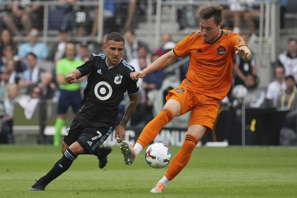 Houston Dynamo forward Corey Baird (11) takes the ball past Minnesota United midfielder Franco Fragapane (7) during the first half of an MLS soccer game Saturday, Aug. 27, 2022 at Allianz Field in St. Paul, Minn. (Anthony Souffle/Star Tribune via AP)