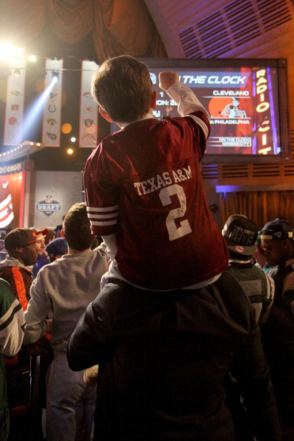 A small fan of Texas A&M reacts after Johnny Manziel (QB) is drafted first round (pick 22) by the Cleveland Browns at Radio City Music Hall for the 2014 NFL Draft on Thursday May 8th, 2014 in New York. (Jamie Herrmann/AP Images)
