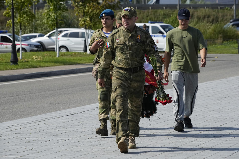 Servicemen walk to attend a farewell ceremony for Dmitry Utkin, who oversaw Wagner Group's military operations, at Federal Military Memorial Cemetery in Mytishchy, outside Moscow, Russia, Thursday, Aug. 31, 2023. Utkin, whose military call sign Wagner gave the name to the group, is presumed to have died in a plane crash along with Wagner's owner Yevgeny Prigozhin and other military company's officers. (AP Photo/Alexander Zemlianichenko)