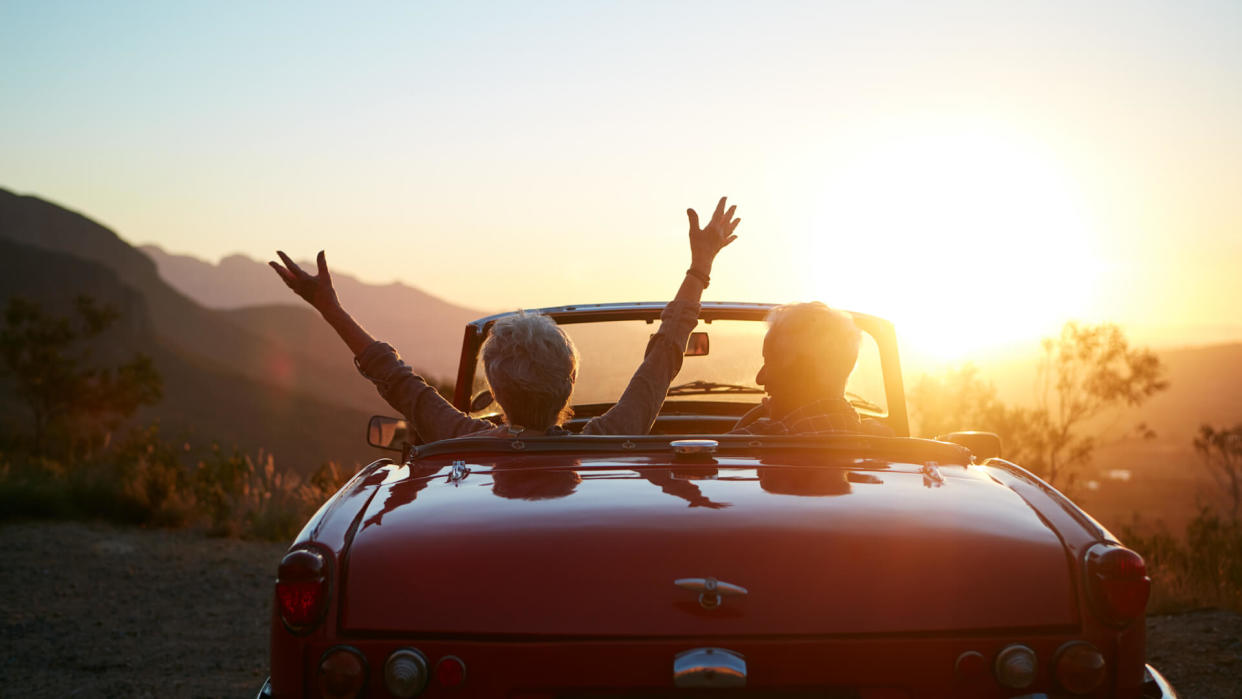 Shot of a joyful senior couple enjoying the sunset during a roadtrip.