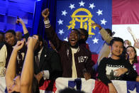 Supporters cheer during an election night watch party for Democratic Sen. Raphael Warnock, Tuesday, Dec. 6, 2022, in Atlanta. Sen. Warnock has defeated Republican challenger Herschel Walker in a runoff election in Georgia. (AP Photo/John Bazemore)