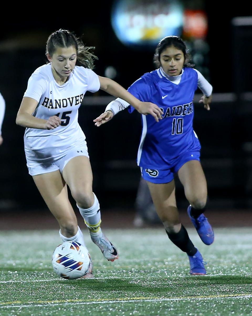Hanover’s Sophia Foley, left, looks to get past Dover-Sherborn's Raina Patel during second-half action of the Division 3 girls soccer state semifinal game at Manning Field in Lynn on Wednesday, November 15, 2023. Hanover would go on to win 2-1 in double overtime.