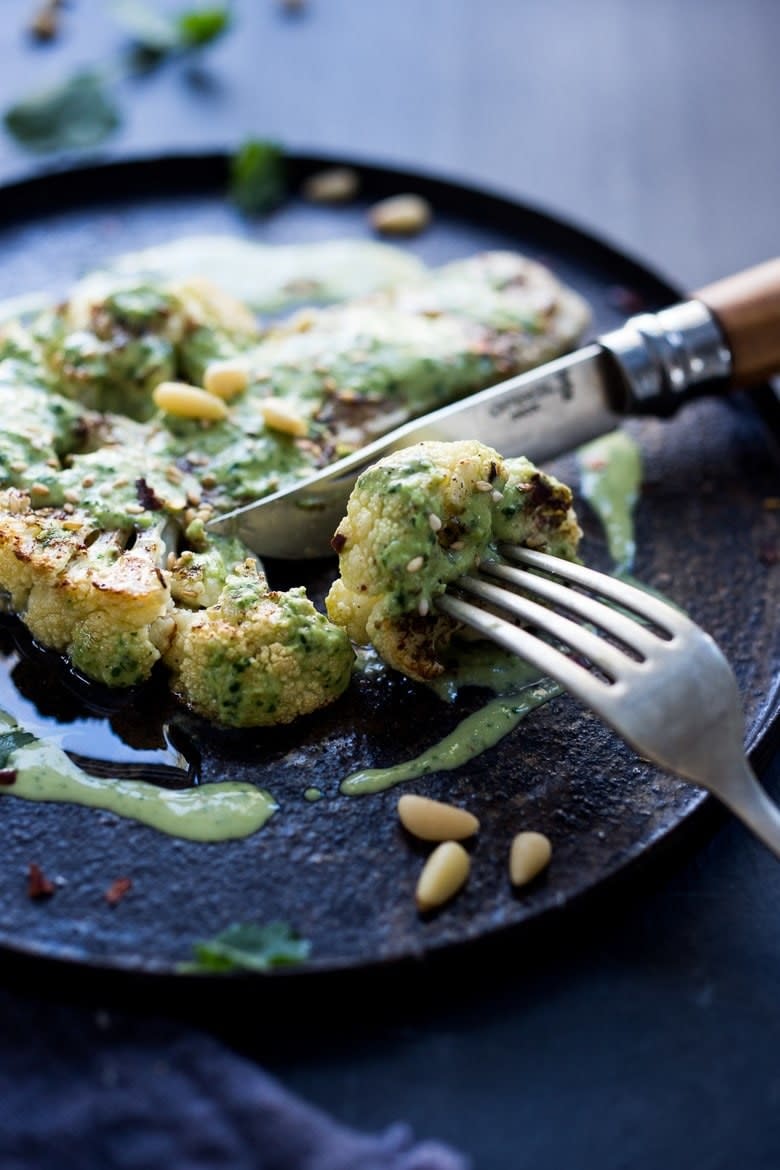 Cutting into a roast cauliflower steak.