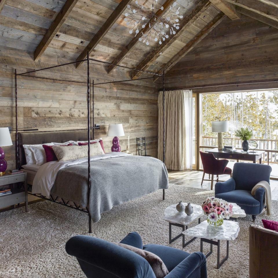 <p>A bright bedroom in Montana features raw wood and neutral colors. Pops of deep blue and purple add color to the space. Design by <a href="https://deringhall.com/interior-designers/kylee-shintaffer" rel="nofollow noopener" target="_blank" data-ylk="slk:Kylee Shintaffer;elm:context_link;itc:0;sec:content-canvas" class="link ">Kylee Shintaffer</a>.</p>