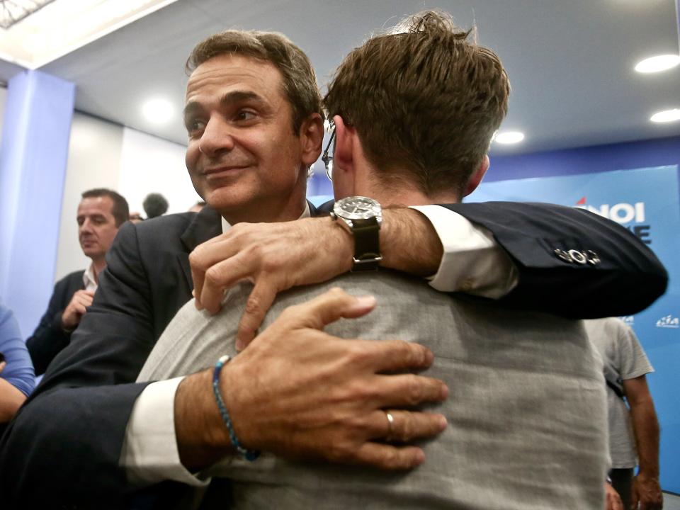 Kyriakos Mitsotakis embraces his son celebrating his victory, at the party's headquarters, after his win at the general election in Athens, Greece, on July 7, 2019