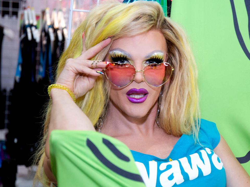 Willam Belli with sunglasses on and hand framing her face