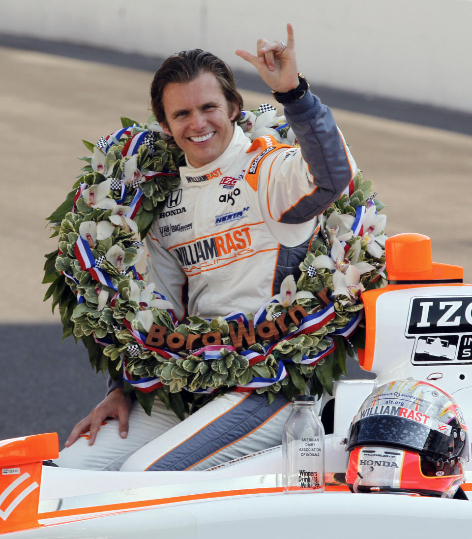 FILE - IndyCar driver Dan Wheldon, of England, signals his second win of the Indianapolis 500 auto race at the Indianapolis Motor Speedway on May 30, 2011, in Indianapolis. Wheldon is the subject of a new HBO documentary "The Lionheart," premiering March 12. (AP Photo/Michael Conroy, File)