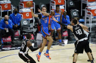 Oklahoma City Thunder forward Aleksej Pokusevski (17) passes the ball against Los Angeles Clippers forward Patrick Patterson (54) and center Ivica Zubac (40) during the second quarter of an NBA basketball game Sunday, Jan. 24, 2021, in Los Angeles. (AP Photo/Ashley Landis)
