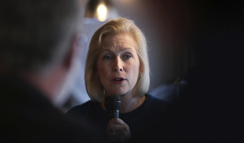 FILE - In this May 10, 2019, file photo, Democratic presidential candidate Sen. Kirsten Gillibrand, D-N.Y., talks with guests during a campaign stop at a coffee shop in Derry, N.H. Gillibrand has released a “Family Bill of Rights” that she vows to institute during her first 100 days in the White House, if elected(AP Photo/Charles Krupa, File)