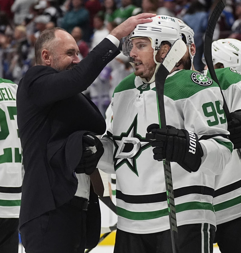 Dallas Stars head coach Peter De Boer, left, congratulates center Matt Duchene after he scored the winning goal in the second overtime of Game 6 of an NHL hockey playoff series against the Colorado Avalanche Friday, May 17, 2024, in Denver. (AP Photo/David Zalubowski)