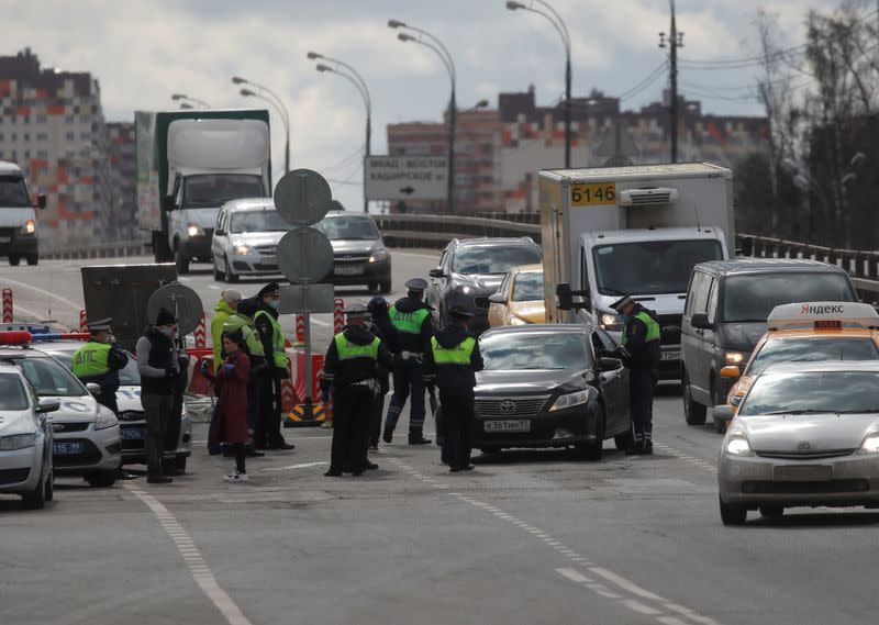Traffic police officers work at a check point on the outskirts of Moscow