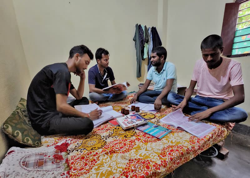 Government job aspirants Rahul Patel, Prem Prakash, Ravi Ranjan and Gupteshwar Kumar take part in a group study as they prepare for railway job in a rented room in Arrah