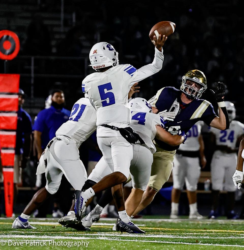 Dover's Nahseem Cosme fires a pass during the Sals' 18-16 win on Friday night at Abessinio Stadium.