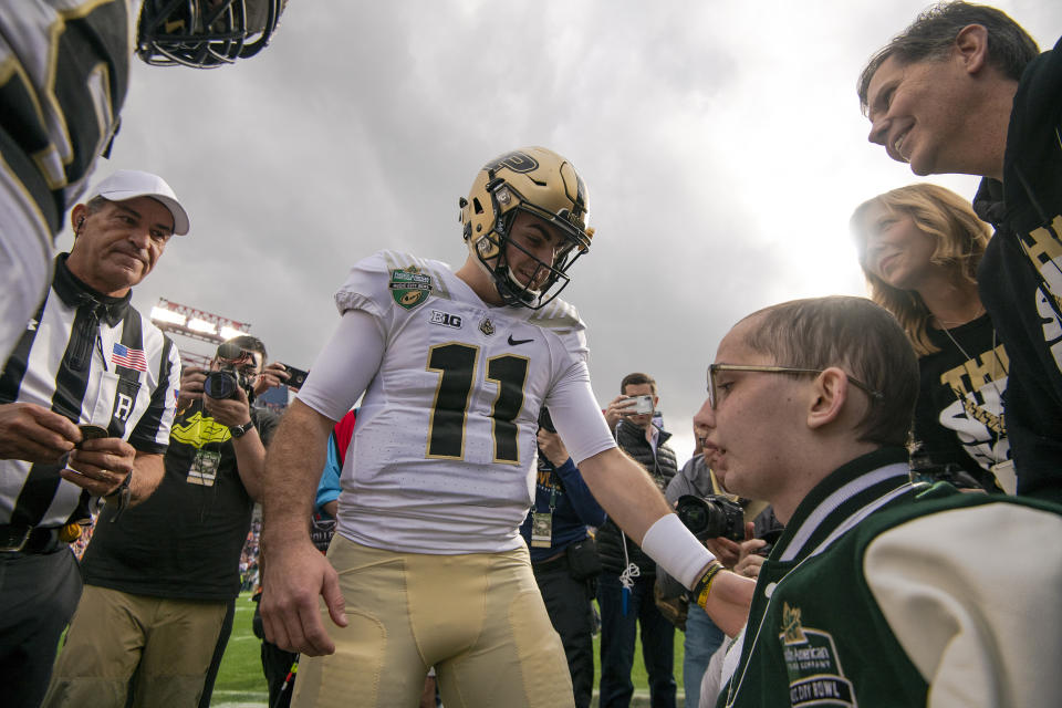 Purdue fan Tyler Trent (R) was a captain at the Music City Bowl. (Photo by Timothy Nwachukwu/Getty Images)