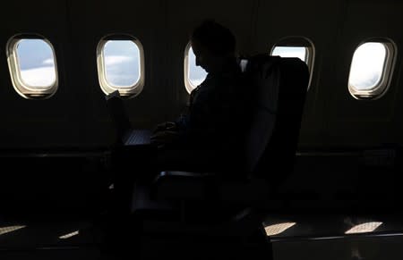 Dominika Pasternak, a Polish PhD student in atmospheric chemistry at Britain's University of York, works on a computer onboard an atmospheric research aircraft en route to the Norwegian Sea from northern Sweden