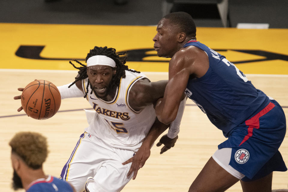 Los Angeles Lakers forward Montrezl Harrell, left, drives toward the basket as Los Angeles Clippers forward Mfiondu Kabengele defends during the second half of an NBA preseason basketball game in Los Angeles, Friday, Dec. 11, 2020. (AP Photo/Kyusung Gong)