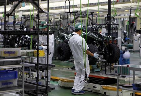 Workers are seen at an assembly line of Honda Motor Co.'s motorcycles at Honda's Kumamoto factory in Ozu town, Kumamoto prefecture, Japan, September 13, 2016. REUTERS/Naomi Tajitsu