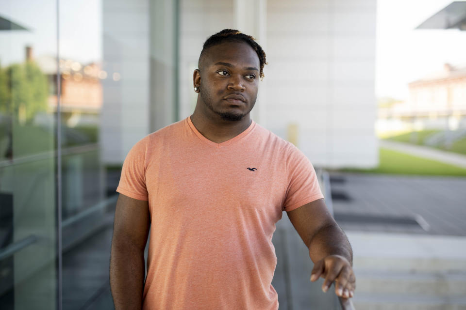 In this Saturday, July 20, 2019 photo, Sanjay Johnson poses for a photo, in Downtown Little Rock, Ark. Johnson was accused of exposing a sexual partner to HIV. Prosecutors in Little Rock pursued a criminal charge against Johnson even though a doctor said he couldn’t have transmitted HIV because he was on medication that suppressed his virus. In roughly 20 states, it’s a crime for people with HIV to have sex without first informing their partner of their infection. (AP Photo/Gareth Patterson)