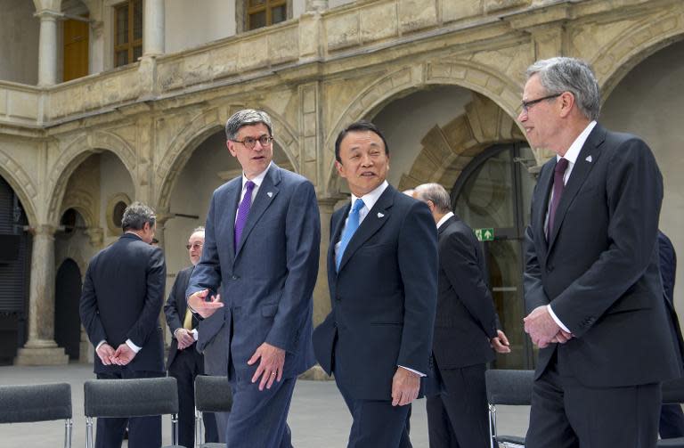 US Secretary of Treasury Jacob Lew (L), Japanese Finance Minister Taro Aso and Canadian Minister of Finance Joe Oliver talk after a family photo during the G7 summit of Finance ministers at the Palace Residenzschloss in Dresden, Germany, May 28, 2015