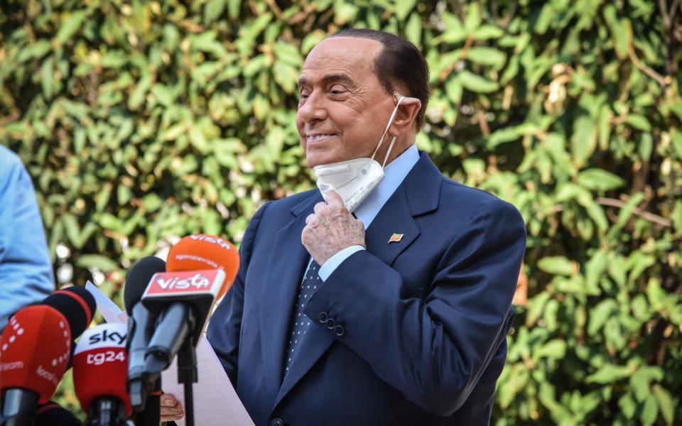 Silvio Berlusconi speaks to the media as he leaves San Raffaele hospital in Milan - Shutterstock