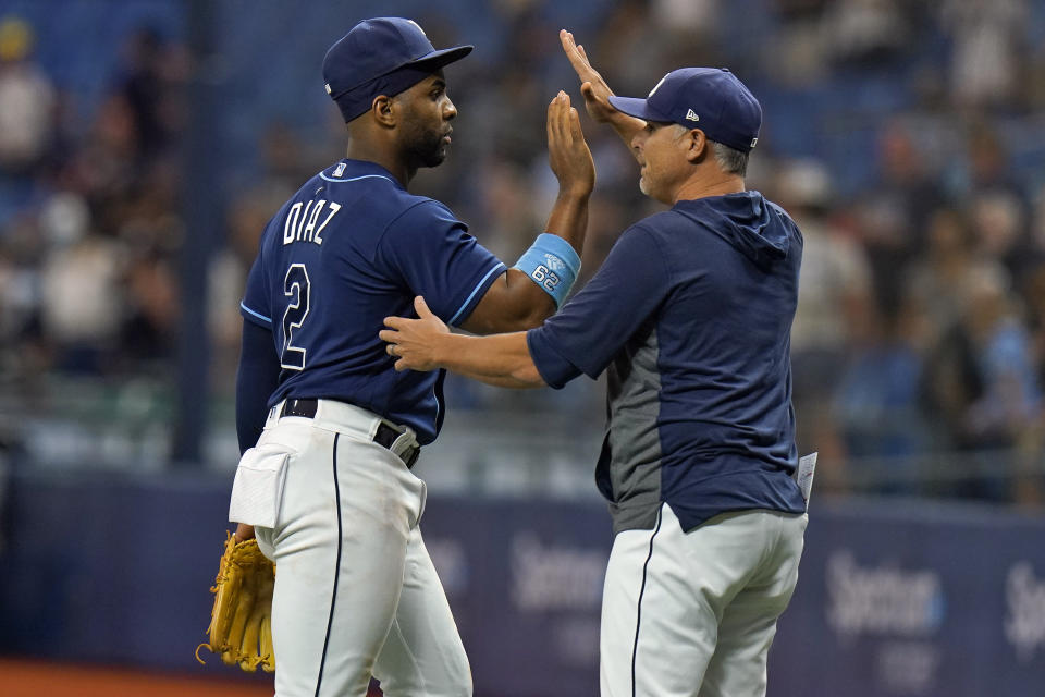 Tampa Bay Rays' Yandy Diaz (2) celebrates with manager Kevin Cash after the Rays defeated the Toronto Blue Jays during a baseball game Wednesday, Sept. 22, 2021, in St. Petersburg, Fla. (AP Photo/Chris O'Meara)