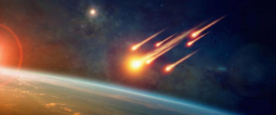 Asteroid impact, end of world, judgment day. Group of burning exploding asteroids from deep space approaches to planet Earth. Elements of this image furnished by NASA