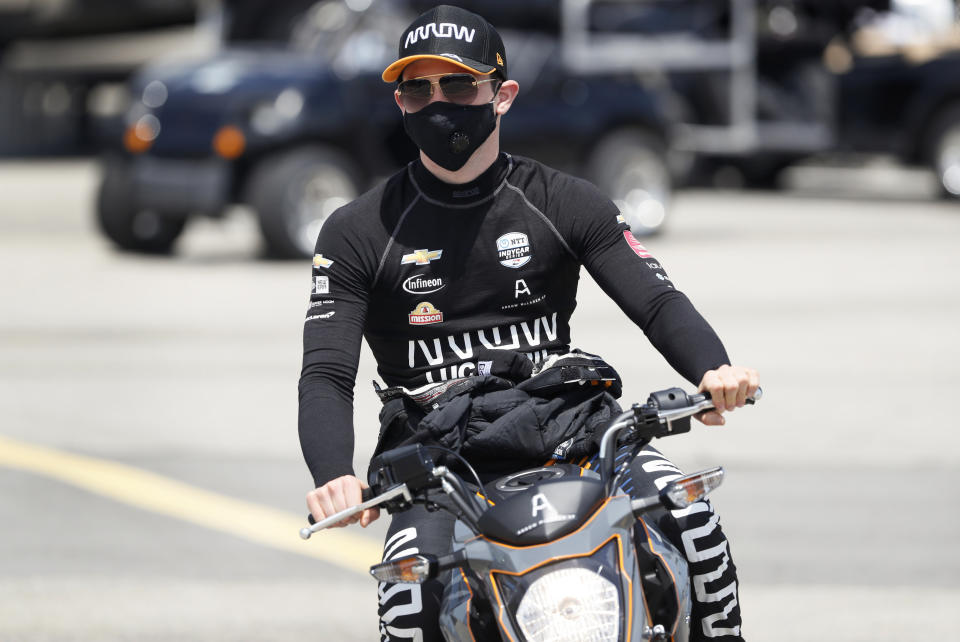 Pato O'Ward, of Mexico, makes his way to his car during practice for an IndyCar Series auto race Saturday, July 18, 2020, at Iowa Speedway in Newton, Iowa. (AP Photo/Charlie Neibergall)