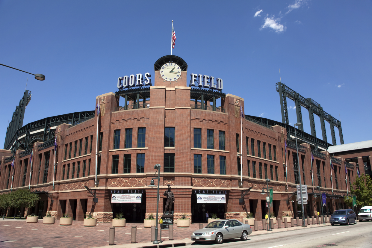 Exterior front of Coors Field, Denver, home of the Colorado Rockies with road and clear blue sky in the background