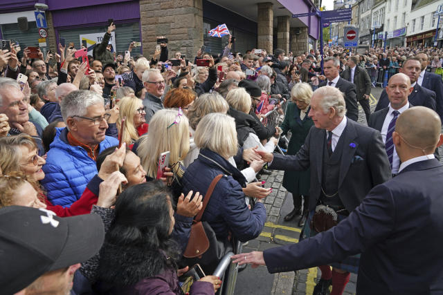 Britain's King Charles III and Camilla, Queen Consort greet well-wishers, as they arrive to attend an official council meeting at the City Chambers in Dunfermline to formally mark the conferral of city status on the former town, ahead of a visit to Dunfermline Abbey to mark its 950th anniversary, in Fife, Scotland, Monday, Oct. 3, 2022. (Andrew Milligan/PA via AP)