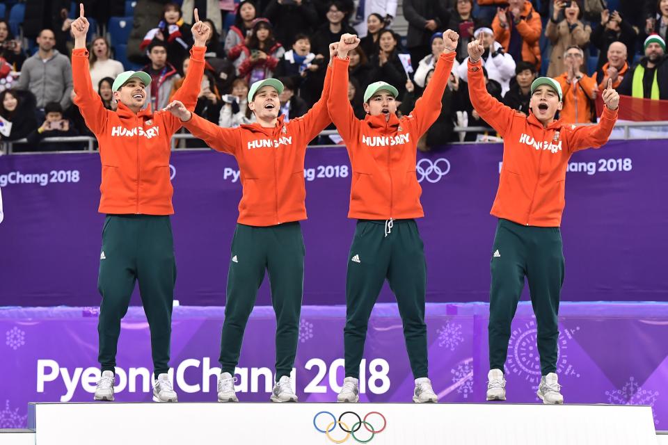 Team Hungary celebrate their gold win on the podium in the men's 5,000m relay short track speed skating on Feb. 22, 2018. | Aris Messinis—AFP/Getty Images