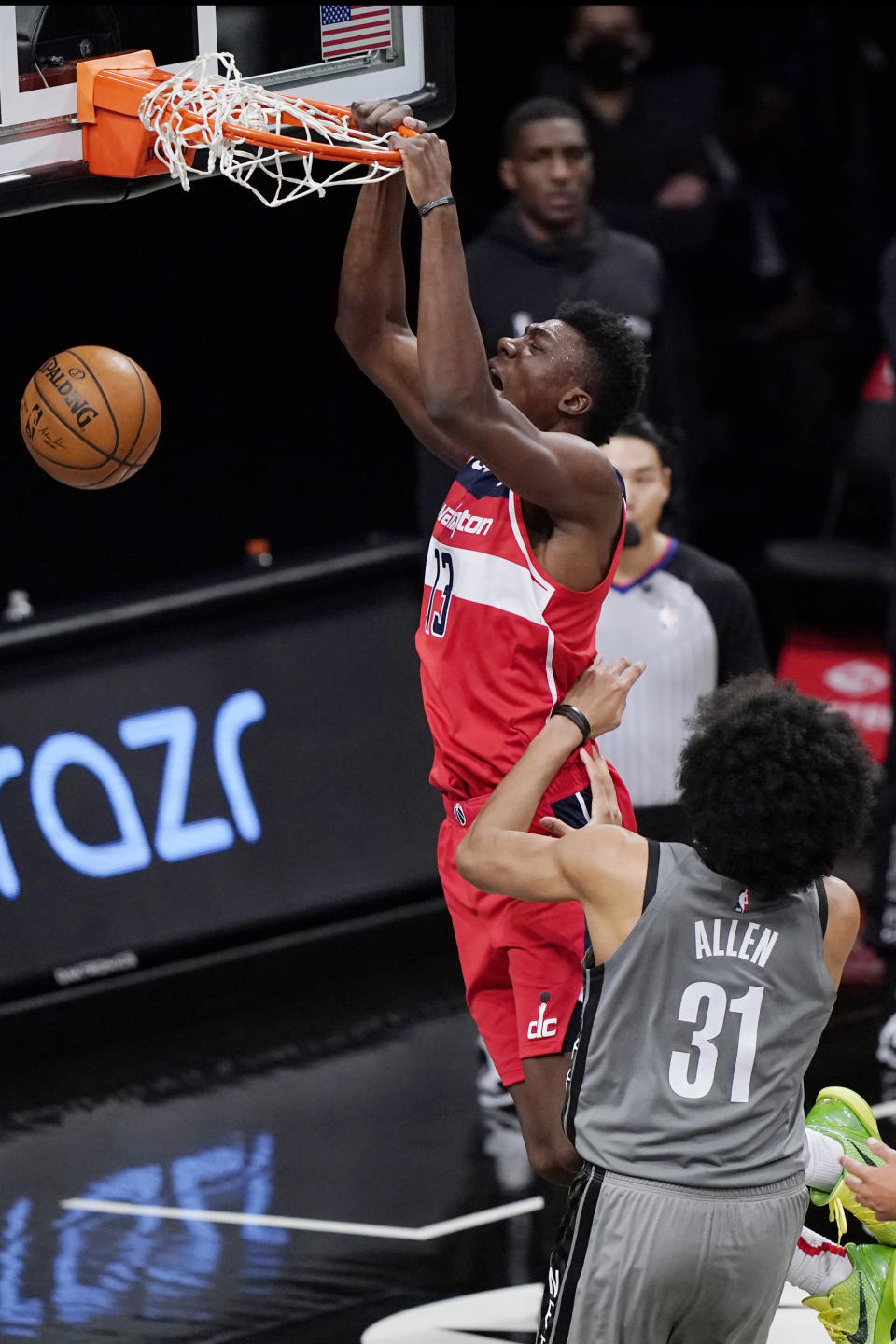 Washington Wizards center Thomas Bryant (13) dunks over Brooklyn Nets center Jarrett Allen (31) during the third quarter of an NBA basketball game, Sunday, Jan. 3, 2021, in New York. (AP Photo/Kathy Willens)