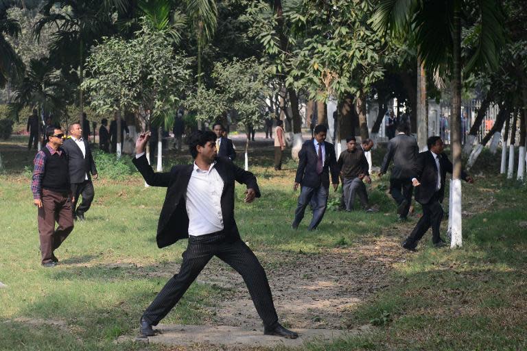 Bangladesh Nationalist Party (BNP) lawyers throw stones towards Bangladesh Awami League supporters outside the High Court in Dhaka on December 30, 2013