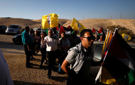 Palestinians arrive to participate in a meeting of Fatah Revolutionary Council at the Bedouin village of Khan al-Ahmar in the occupied West Bank July 12, 2018. REUTERS/Mohamad Torokman