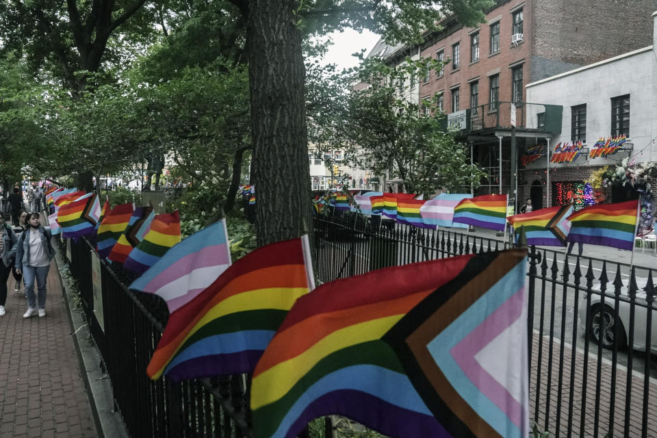Flags affirming LGBTQ identity dress the fencing surrounding the Stonewall National Monument, Wednesday, June 22, 2022, in New York. Sunday's Pride Parade wraps a month marking the anniversary of the June 28th, 1969, Stonewall uprising, sparked by a police raid on a gay bar in Manhattan and a catalyst of the modern LGBTQ movement. (AP Photo/Bebeto Matthews)