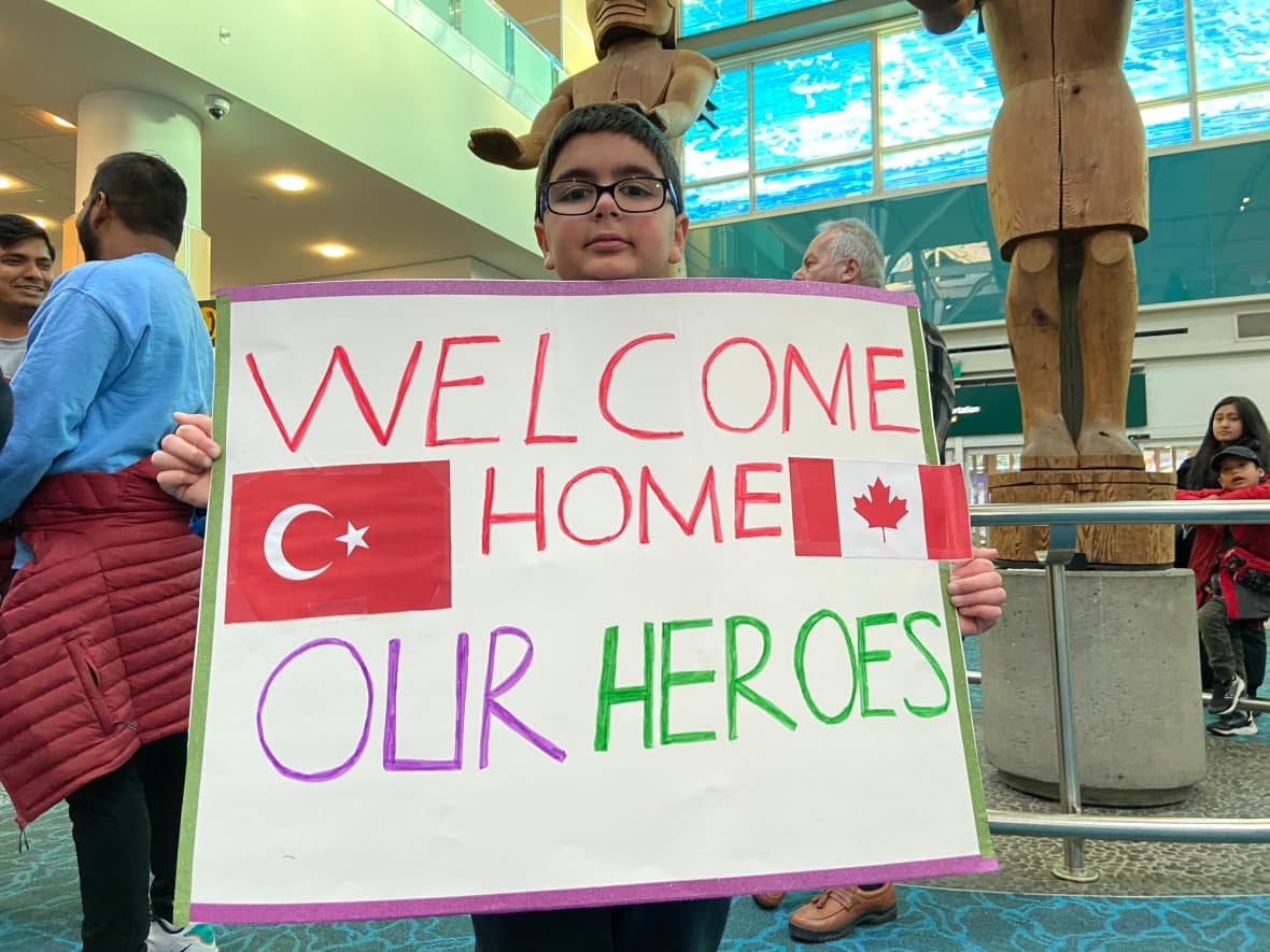 Akif Asilturk, 9, was among the many on hand to greet the Burnaby Urban Search and Rescue Team as they arrived. (Dan Burritt/CBC - image credit)