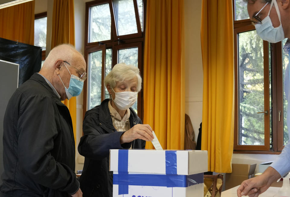 A couple cast their ballots for the abortion referendum, at a polling station in San Marino, Sunday, Sept. 26, 2021. Tiny San Marino is one of the last countries in Europe which forbids abortion in any circumstance — a ban that dates from 1865. Its citizens are voting Sunday in a referendum calling for abortion to be made legal in the first 12 weeks of pregnancy. (AP Photo/Antonio Calanni)