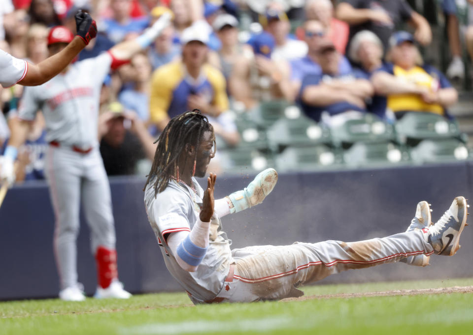 Cincinnati Reds' Elly De La Cruz reacts after he scores against the Milwaukee Brewers during the third inning of a baseball game Sunday, June 16, 2024, in Milwaukee. (AP Photo/Jeffrey Phelps)