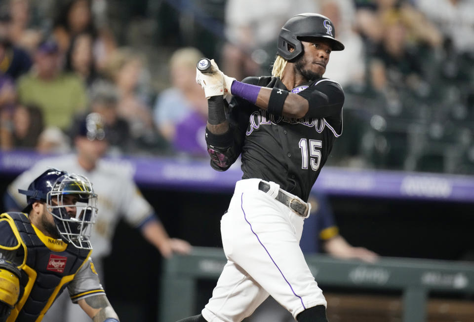 Colorado Rockies' Raimel Tapia watches his RBI single off Milwaukee Brewers relief pitcher Eric Yardley during the sixth inning of a baseball game Thursday, June 17, 2021, in Denver. (AP Photo/David Zalubowski)