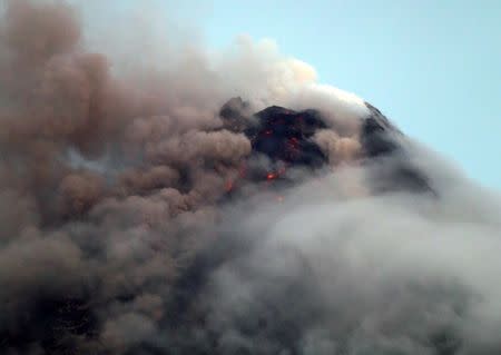 Clouds partially cover Mayon volcano's crater as it spews a column of ash during another mild eruption in Legazpi City, Albay province, south of Manila, Philippines January 16, 2018. REUTERS/Stringer