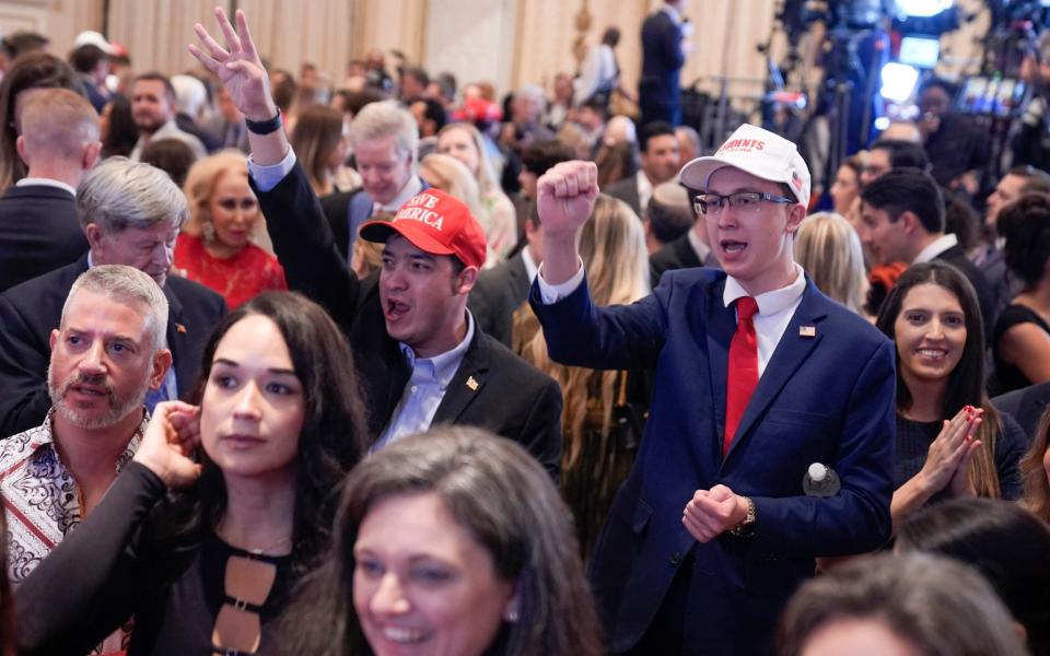 Supporters celebrate before Donald Trump speaks at a Super Tuesday election night party
