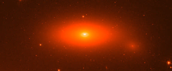 This image shows the disk galaxy NGC 1277, as seen by the Hubble Space Telescope. The small, flattened galaxy has one of the biggest central super-massive black holes ever found in its center, the equivalent of 17 billion suns.