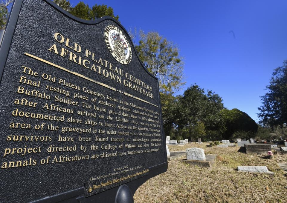 FILE - In this Tuesday, Jan. 29, 2019, file photo, Old Plateau Cemetery, the final resting place for many who spent their lives in Africatown, stands in need of upkeep near Mobile, Ala. Many of the survivors of the slave ship Clotilda's voyage are buried here among the trees. On Wednesday, May 22, 2019, authorities said that researchers have located the wreck of Clotilda, the last ship known to bring enslaved people from Africa to the United States. (AP Photo/Julie Bennett, File)