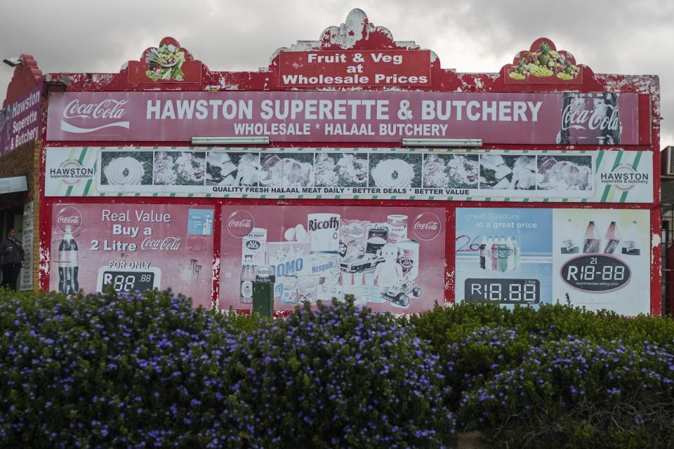 A superette, a small supermarket, and a butchery shop are some of the very few businesses still open in the seaside fishing village of Hawston, South Africa, April 27, 2023. Abalone here was abundant, yet the demand largely put the village and its traditional fishers out of business, or made them criminals overnight. (AP Photo/Jerome Delay)