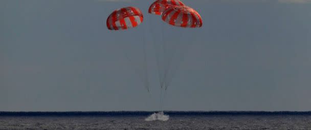 PHOTO: In this photo provided by NASA the Orion spacecraft for the Artemis I mission splashes down in the Pacific Ocean after a 25.5 day mission to the Moon, Dec. 11, 2022. (Kim Shiflett/AP)