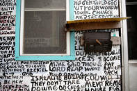 Words are seen on the facade of Archie Hurt's house in Memphis, Tennessee, U.S., March 29, 2018. Hurt, who regards Martin Luther King Jr. as a prophet, has been painting parts of Biblical scripture interspersed with his thoughts on religion, politics and current events on the front of his house for ten years and twenty years before that when it was his brother's house. REUTERS/Jonathan Ernst